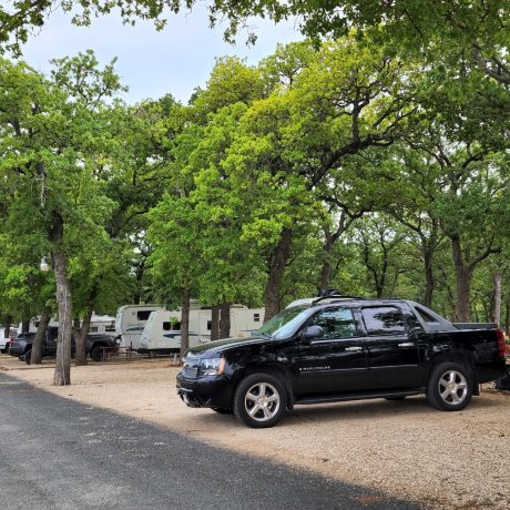 RV parked in spacious shady sites with full hookups and beautiful Texas views at Oakwood RV Resort in Fredericksburg, TX.